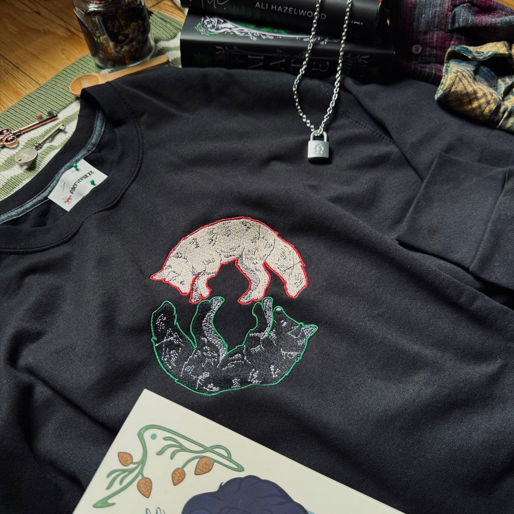 Black sweatshirt with dual wolves embroidered design.