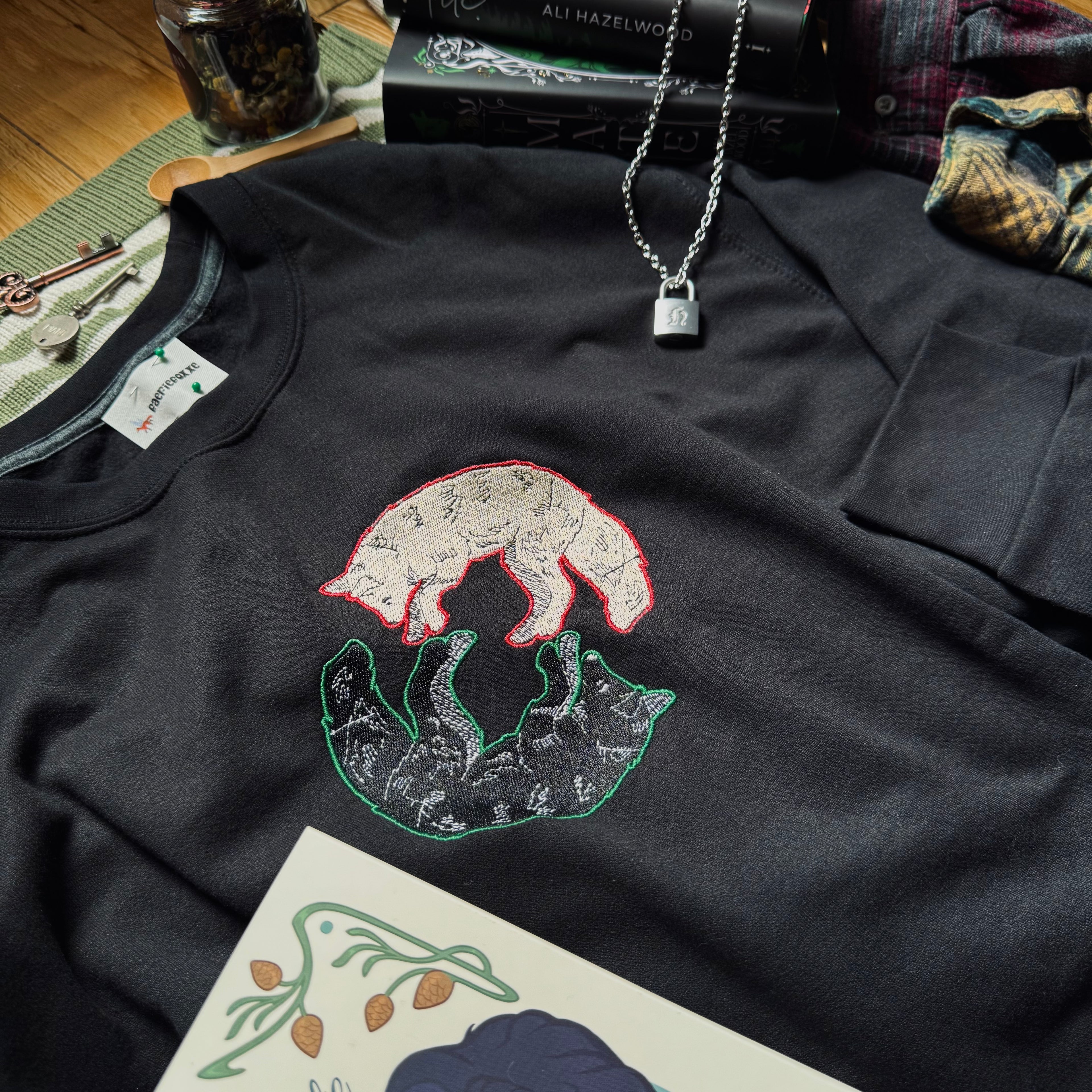 Black sweatshirt with dual wolves embroidered design.