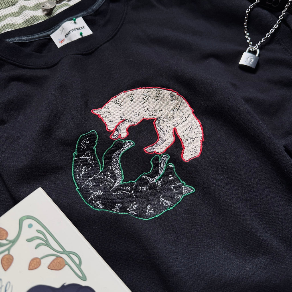 Black sweatshirt with dual wolf embroidered design.