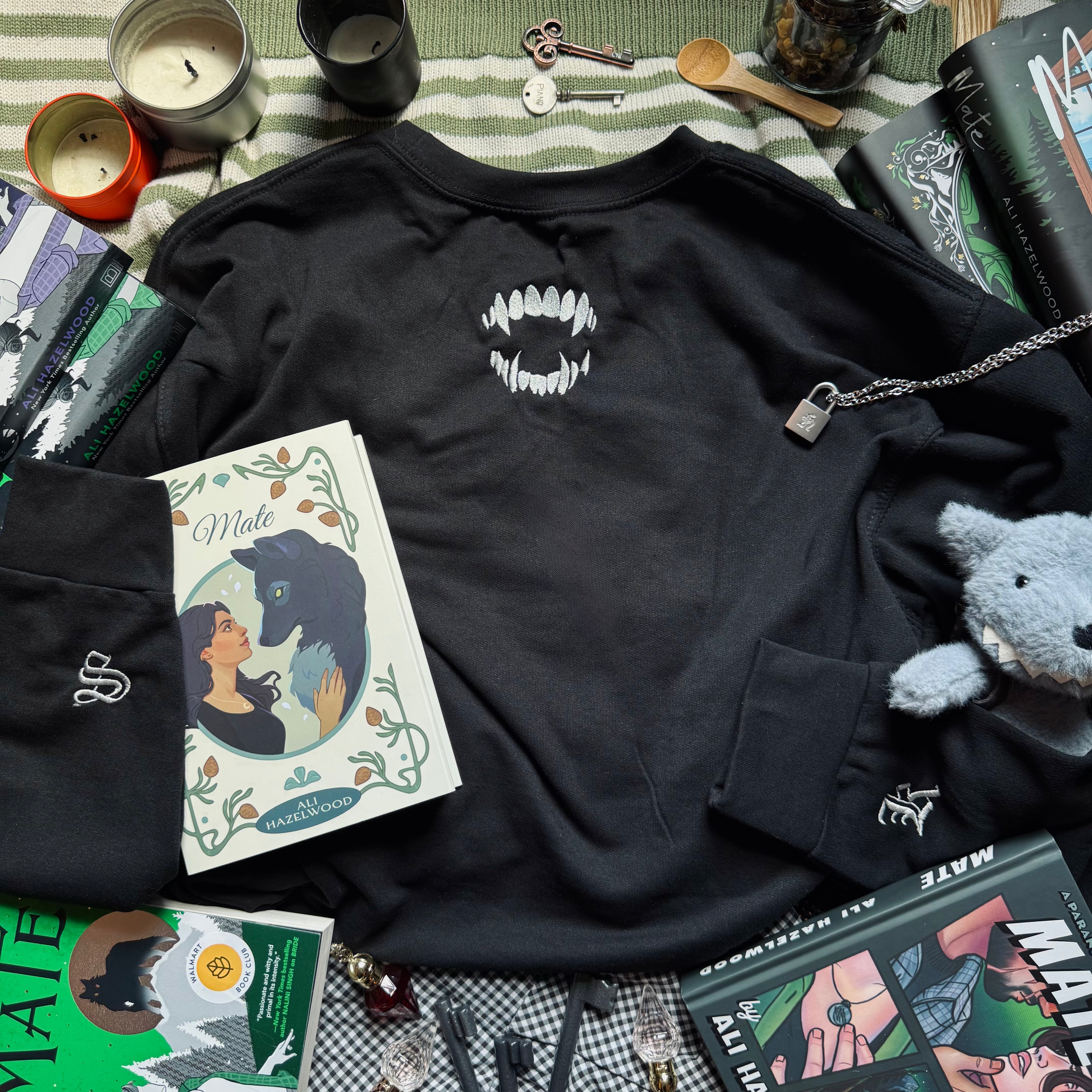 Black sweatshirt with bite embroidered design.
