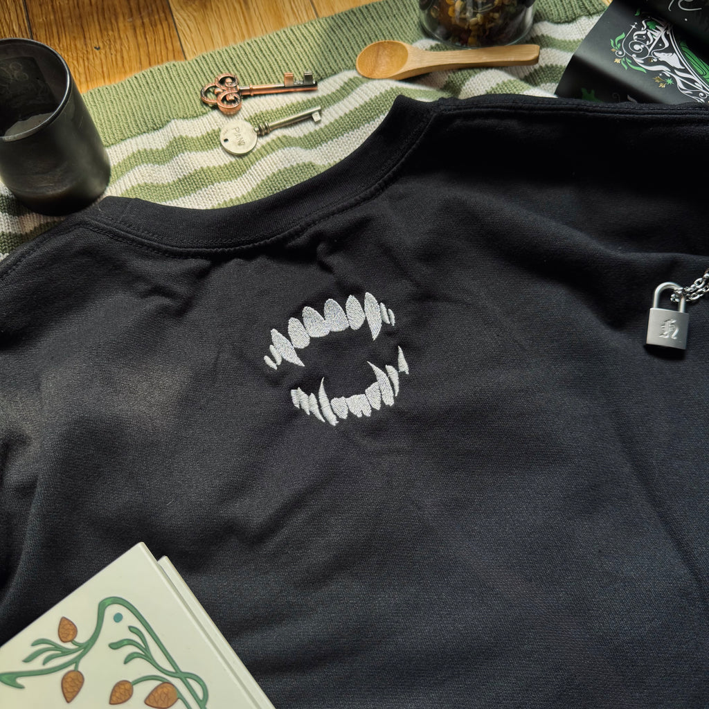 Black sweatshirt with bite mark embroidered design.