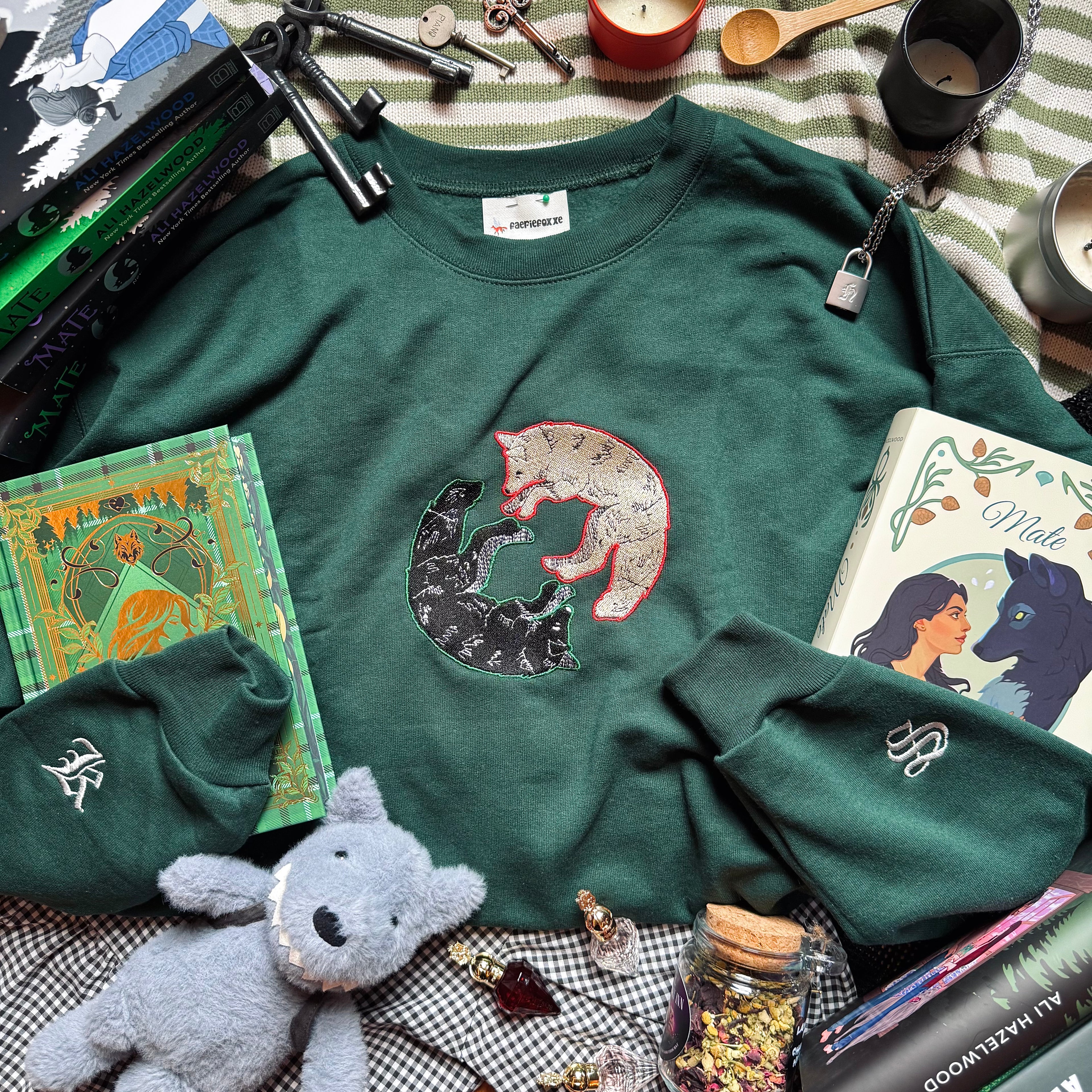 Green sweatshirt with wolf design on a the front.
