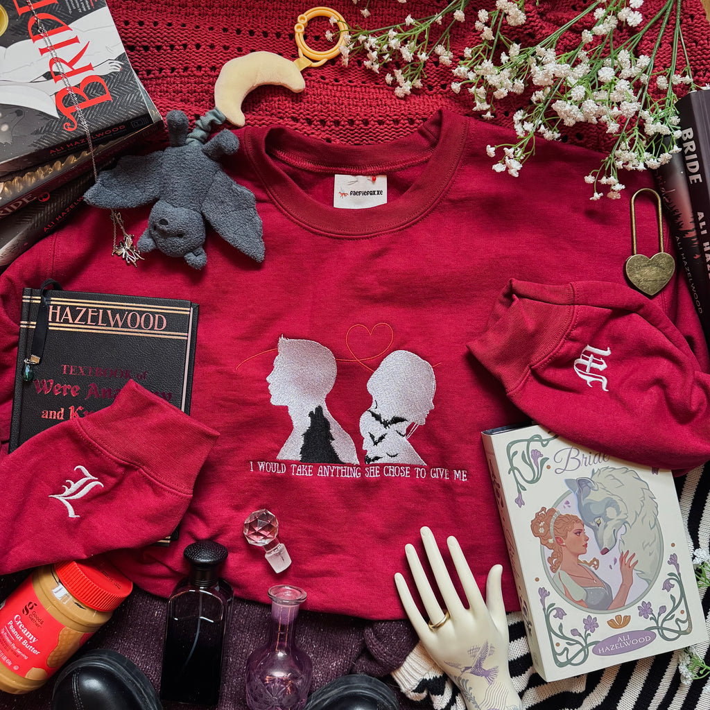 Red sweatshirt with silhouette design on the front. 