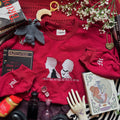 Red sweatshirt with silhouette design on the front. 