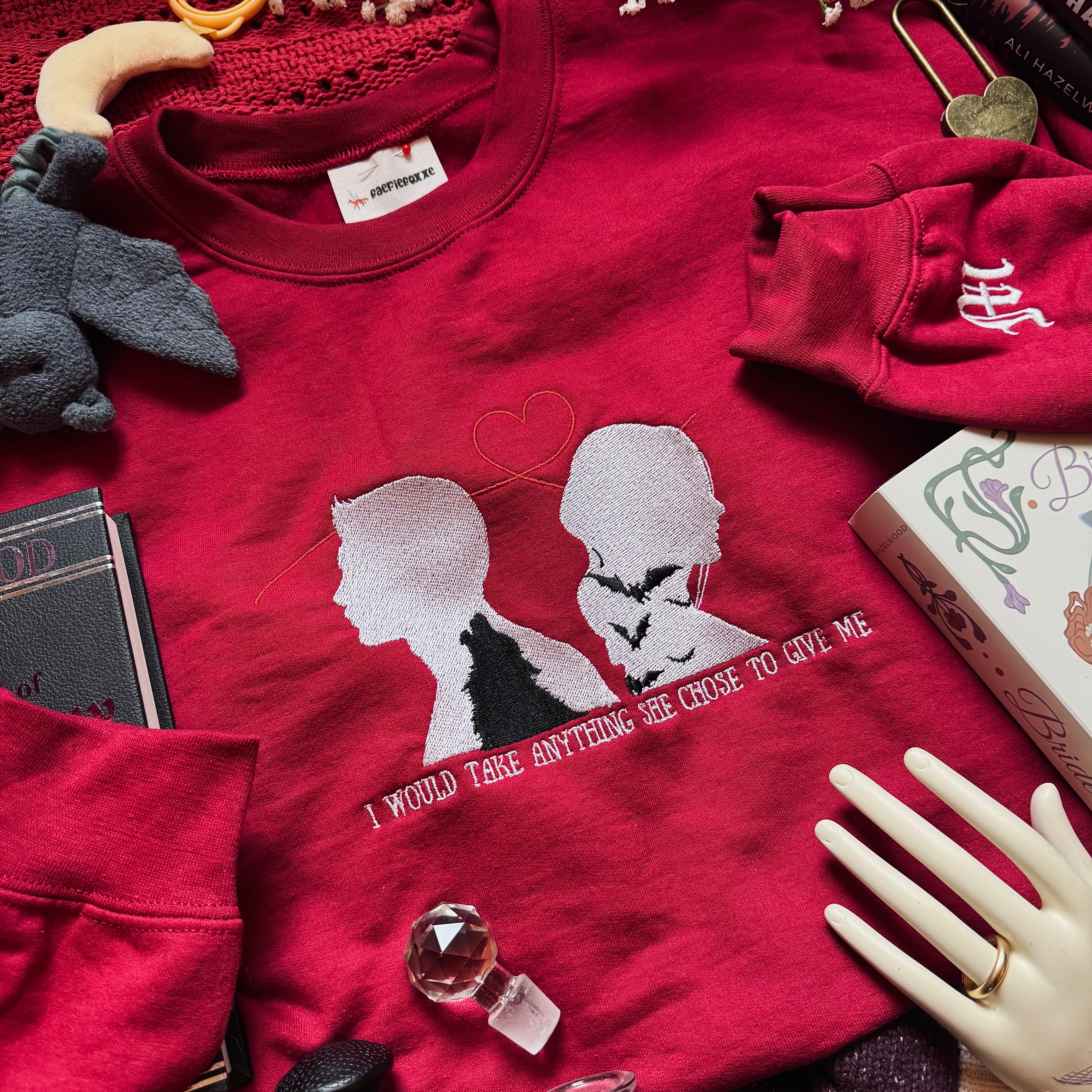 Red sweatshirt with couple silhouette embroidered. 