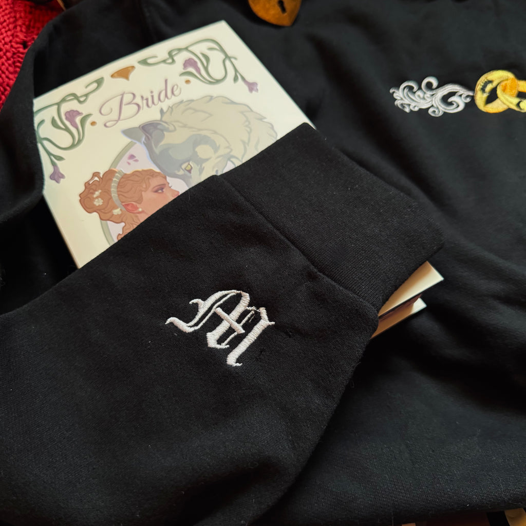Black sweatshirt with embroidered M. 