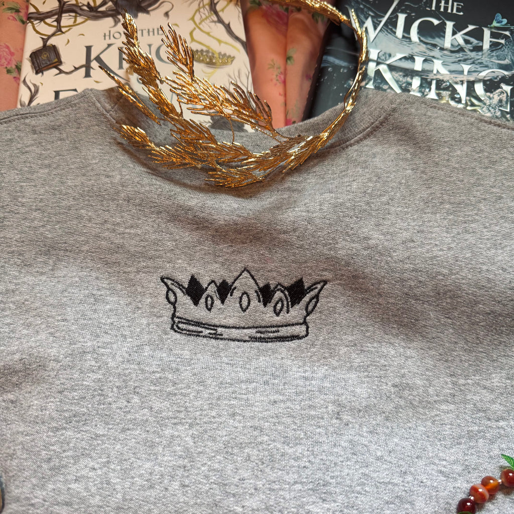 Gray sweatshirt with a crown design.