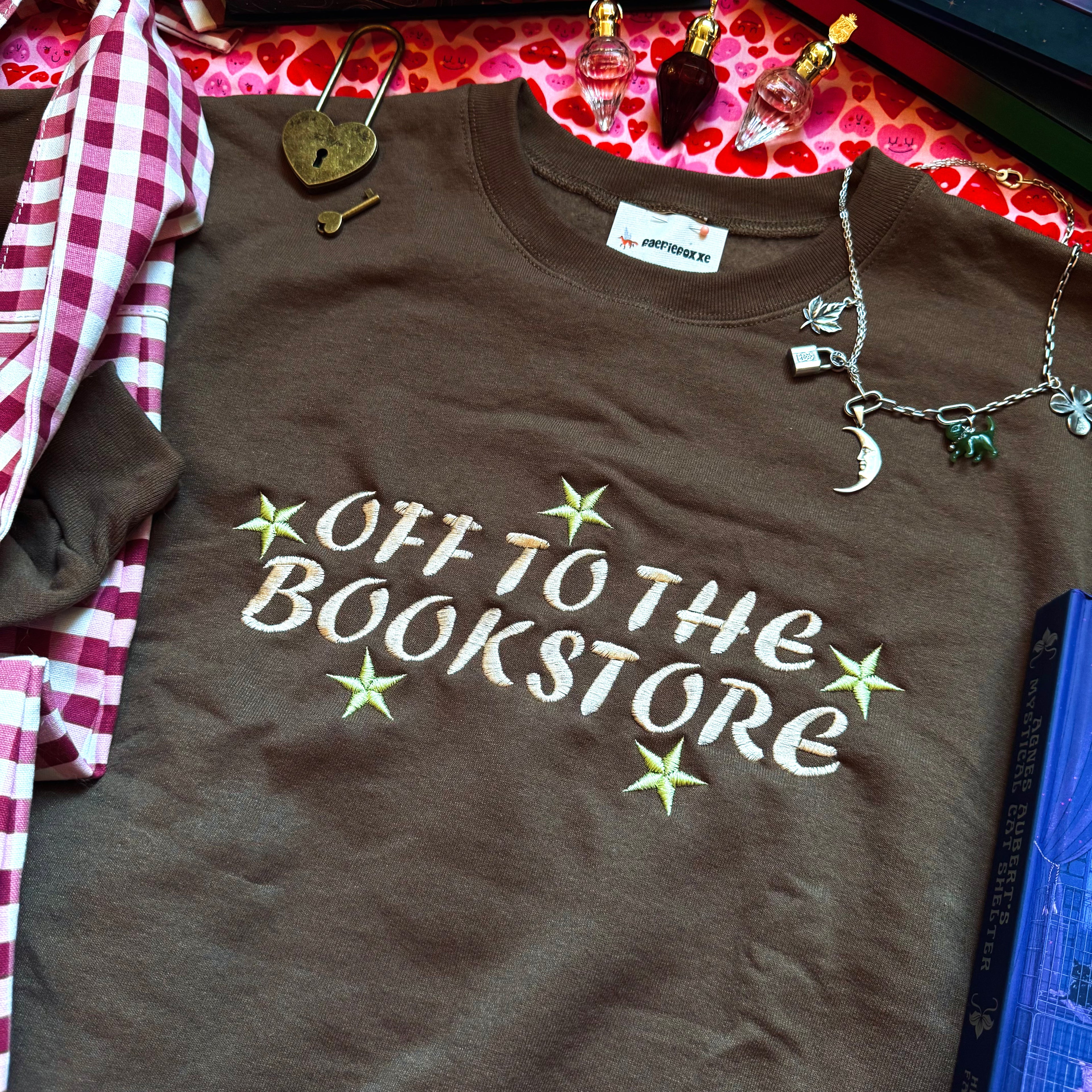 Brown sweatshirt with embroidered design on the front.