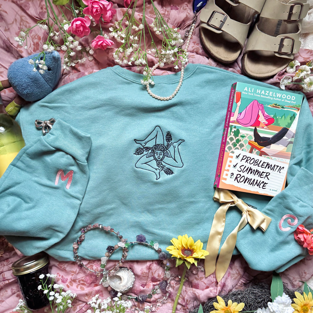 Teal sweatshirt with embroidered design based on Problematic Summer Romance by Ali Hazelwood.