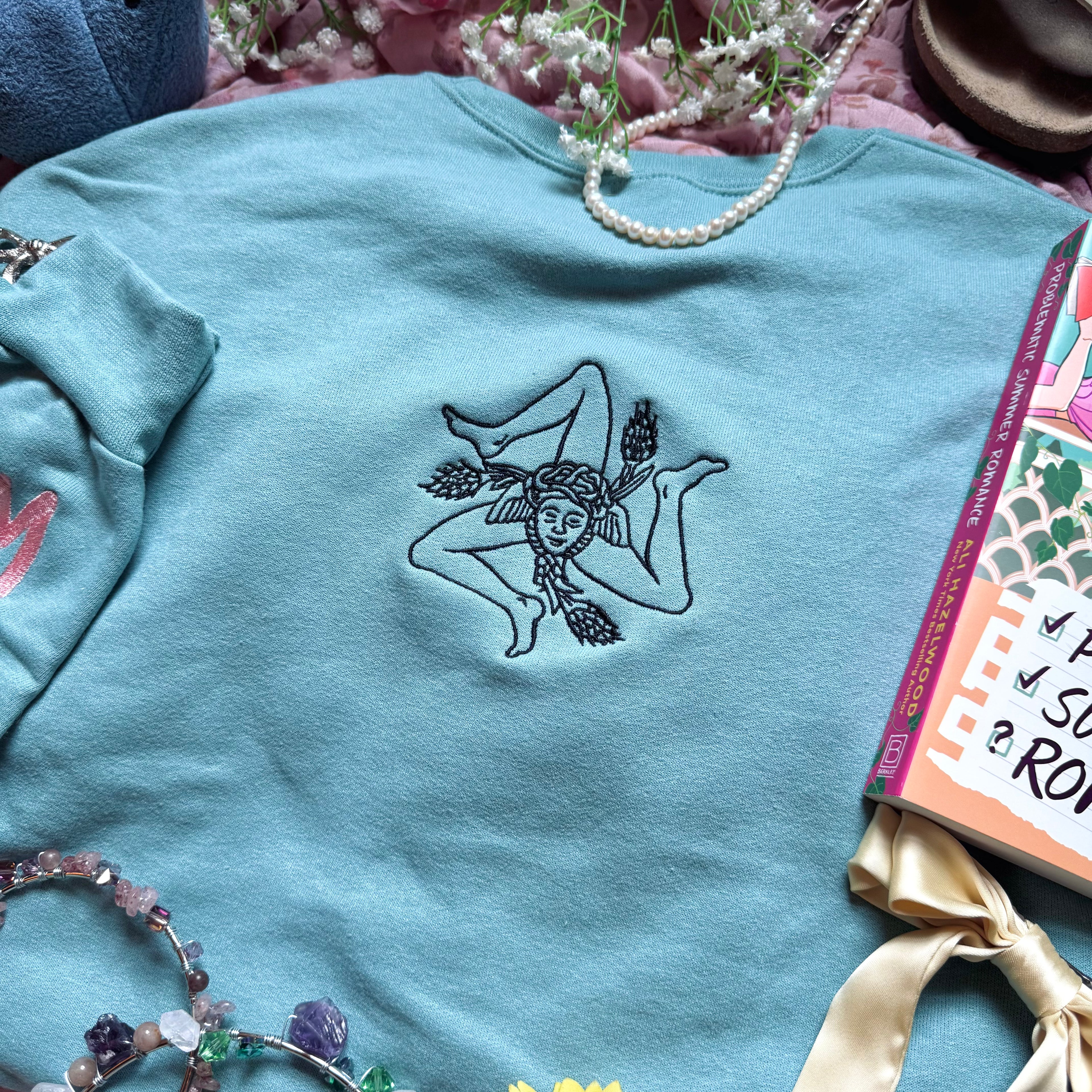 Teal sweatshirt with embroidered design based on Problematic Summer Romance by Ali Hazelwood.