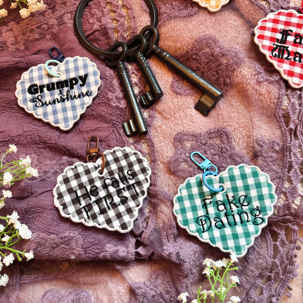 Keychain with decorative tags on a textured fabric background