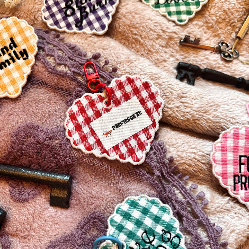 Collection of decorative keychains and tags on a textured surface
